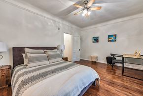 Hollywood apartment for rent - a bedroom with a large bed and a ceiling fan