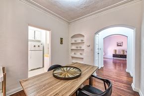 Hollywood apartment for rent - a dining room with a wooden table and black chairs