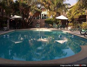 La Habra apartment for rent - a swimming pool with umbrellas and chairs around it