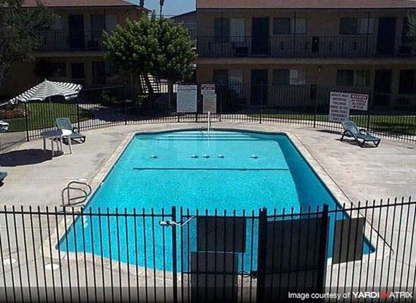 Whittier apartment for rent - a swimming pool in front of an apartment building