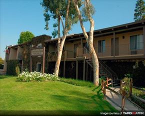 Anaheim apartment for rent - a building with two trees in front of it