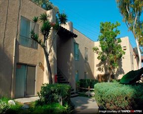 Anaheim apartment for rent - an apartment building with a courtyard and trees