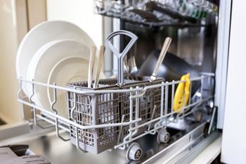 A dishwasher filled with dishes and utensils