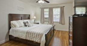 Rahway apartment for rent - a bedroom with a bed and a dresser and two windows