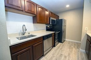 Franklin apartment for rent - a kitchen with stainless steel appliances and wooden cabinets