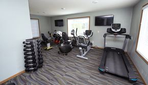 Franklin apartment for rent - a gym with cardio equipment and a tv in the corner of a room
