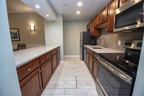 New Berlin apartment for rent - a kitchen with wooden cabinets and stainless steel appliances