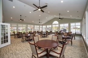 New Berlin apartment for rent - a large dining room with tables and chairs and windows