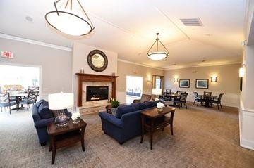Neenah apartment for rent - a living room with couches and tables and a fireplace