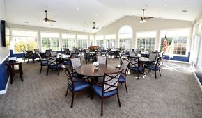 Neenah apartment for rent - a large dining room with tables and chairs and windows