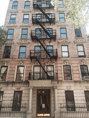 New York apartment for rent - a brick building with fire escapes on the side of it