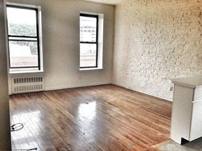 New York apartment for rent - an empty living room with wood floors and two windows