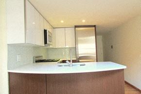 New York apartment for rent - an empty kitchen with white cabinets and a sink
