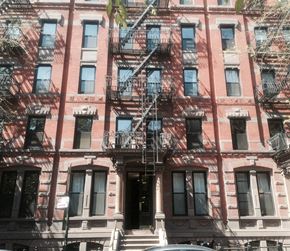 New York apartment for rent - a building with a fire escape on the side of it