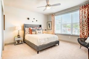 Charlotte apartment for rent - a bedroom with a bed and a ceiling fan