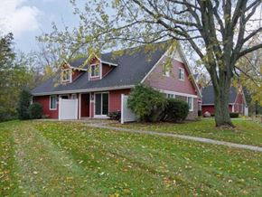 Temperance townhouse for rent - a red house with a yard and trees