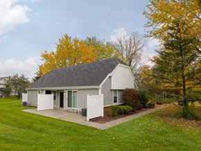 Temperance townhouse for rent - a small white house with a yard and trees