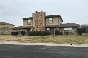 Denton townhouse for rent - a house with a brick and stone facade on a street