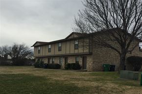 Denton townhouse for rent - a house with a yard and a tree in front of it
