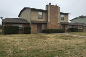 Denton townhouse for rent - a house with a yard in front of it