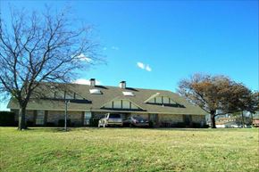Denton triplex for rent - a large house with two cars parked in front of it