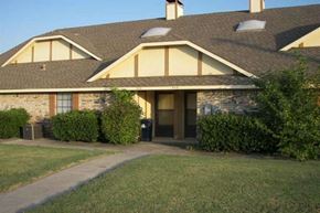 Denton triplex for rent - a house with a lawn in front of it
