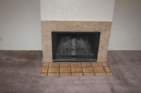 Denton triplex for rent - a fireplace in a living room with a tile floor