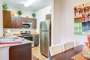 Austin apartment for rent - Dinning room looking into kitchen with stainless steal appliances
