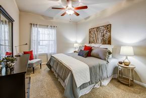 Austin apartment for rent - Apartments In Austin, TX - Spacious Bedroom With Plush Carpet Flooring, Ceiling Fan, Large Window, And Modern Décor.