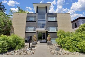 Denver apartment for rent - the front of a condo building with a sidewalk and plants