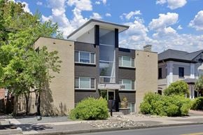 Denver apartment for rent - a brick apartment building with a street in front of it