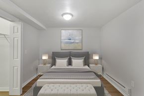 Denver apartment for rent - a bedroom with a bed and two nightstands and a painting