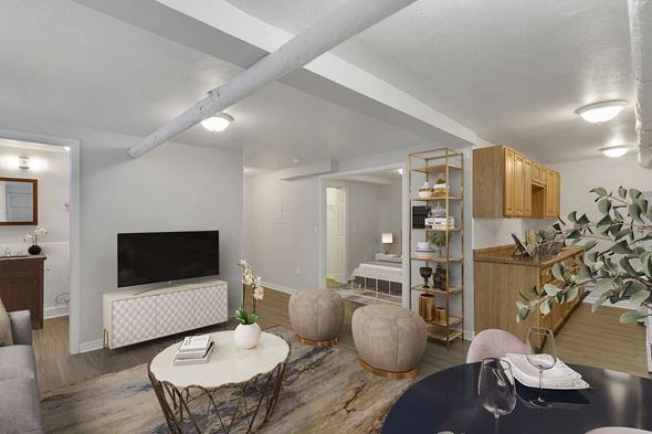Denver apartment for rent - a living room with a tv and a table and chairs
