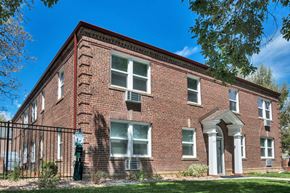 Denver apartment for rent - an old brick building with a fence in front of it