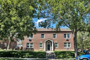 Denver apartment for rent - a large brick house with trees in front of it