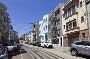 San Francisco apartment for rent - A street with cars parked on both sides and buildings on the side.