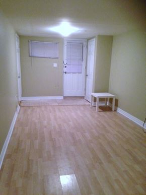 Toronto apartment for rent - A room with a white door and a table.
