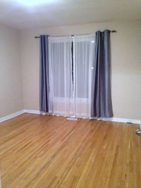 Toronto apartment for rent - A room with a window covered by a grey curtain.