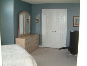 Markham apartment for rent - A bedroom with a bed, dresser, mirror and chair.