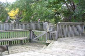 Toronto apartment for rent - A wooden deck with a bench and a table.
