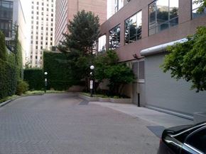 Toronto apartment for rent - A black car is parked on a brick road.