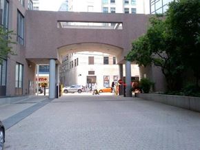 Toronto apartment for rent - A large building with a covered walkway in front.