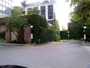 Toronto apartment for rent - A brick road leads to a building with a white tower.