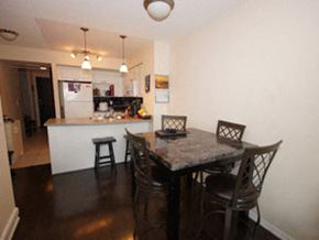 Toronto apartment for rent - A kitchen with a table and chairs in front of it.