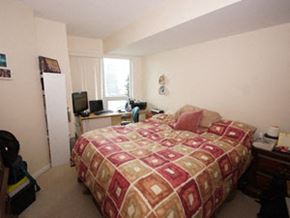 Toronto apartment for rent - A bedroom with a bed, desk, chair, and window.