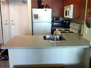 Toronto apartment for rent - A kitchen with a white fridge and a white stove.