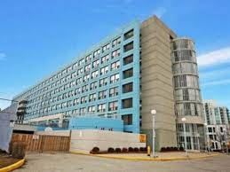 Toronto apartment for rent - A large, modern building with a blue and beige facade.