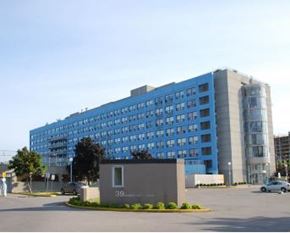 Toronto apartment for rent - A large blue building with a grey sign in front of it.