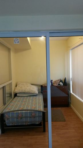 Toronto apartment for rent - A bedroom with a bed and a window.