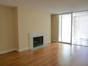 Toronto apartment for rent - A living room with a fireplace and sliding glass doors.